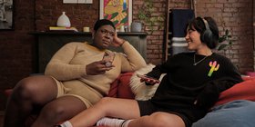 A non-binary trans woman and a non-binary person enjoying time on the couch.jpg
