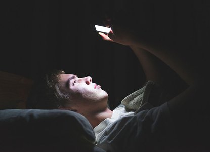 Boy in bed on phone.jpeg