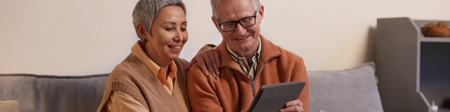 man and woman on ipad