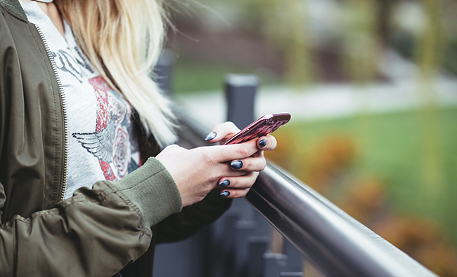 Teenage girl on phone.png