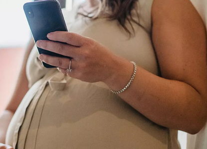 pregnant lady on mobile phone.webp