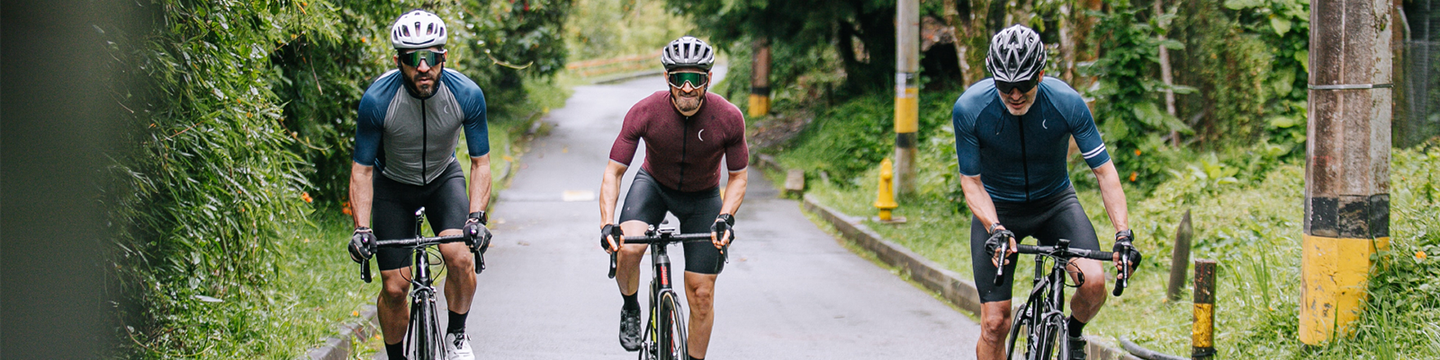 three men cycling on a forest road.png