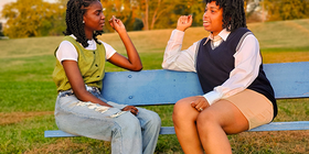 Two young women on park bench.png